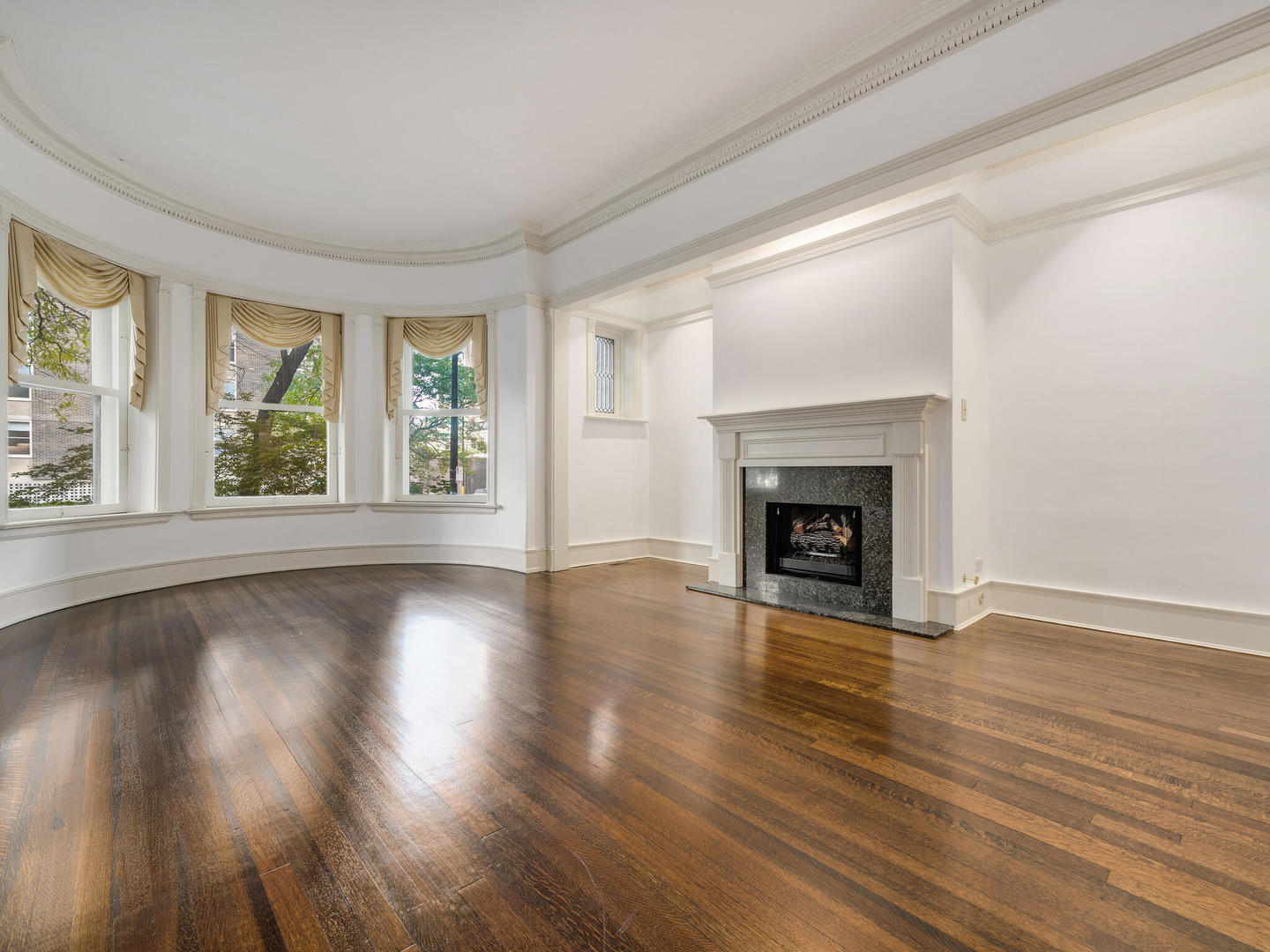 3020 North Sheridan Road, Unit 1N Chicago, IL 60657 - Photo 6 of 29 a view of an empty room with wooden floor and a window
