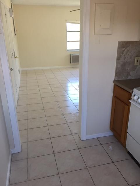 101 South Golfview Road, Unit 16 Lake Worth Beach, FL 33460 - Photo 16 of 16 a view of a livingroom with wooden floor and a window