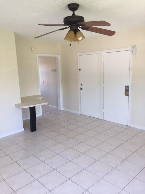 101 South Golfview Road, Unit 16 Lake Worth Beach, FL 33460 - Photo 9 of 16 a bedroom with a bed and a chandelier fan