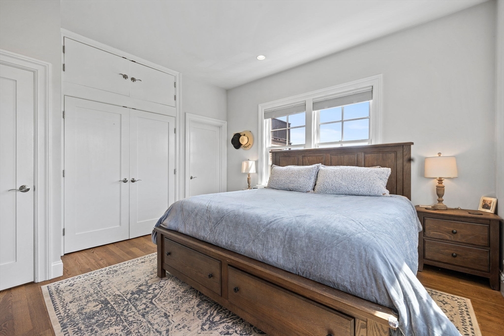 25 Mercer Street, Unit PH5 Boston, MA 02127 - Photo 13 of 22 a bedroom with a bed and a dresser