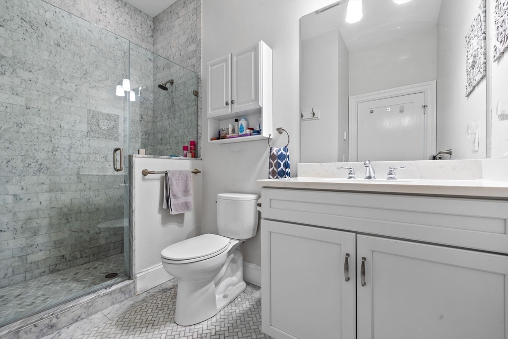 25 Mercer Street, Unit PH5 Boston, MA 02127 - Photo 14 of 22 a bathroom with a sink a toilet and shower