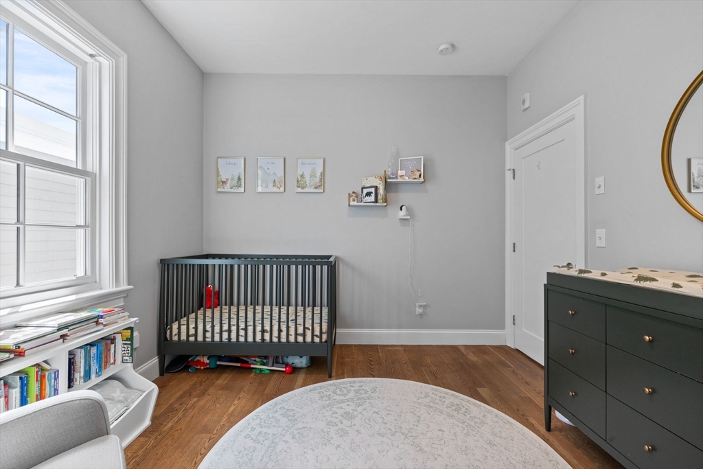 25 Mercer Street, Unit PH5 Boston, MA 02127 - Photo 16 of 22 a bedroom with furniture and a window