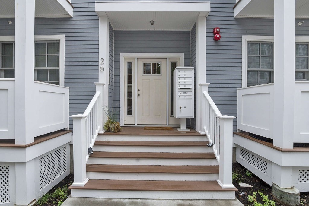 25 Mercer Street, Unit PH5 Boston, MA 02127 - Photo 21 of 22 a view of stairs with wooden floor and a front door