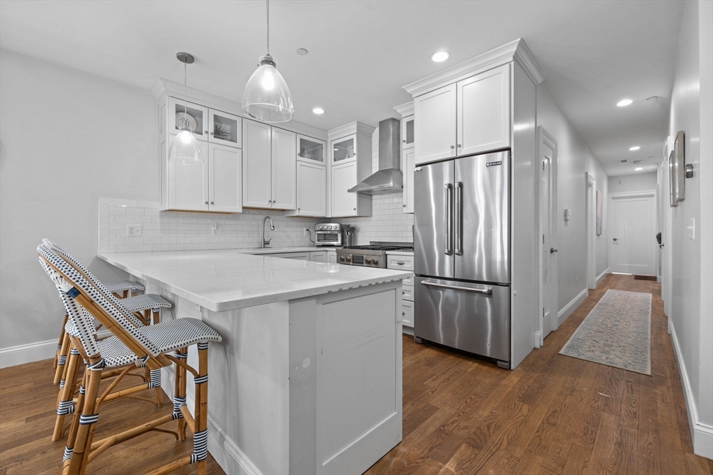 25 Mercer Street, Unit PH5 Boston, MA 02127 - Photo 4 of 22 a kitchen with a refrigerator a sink and a stove