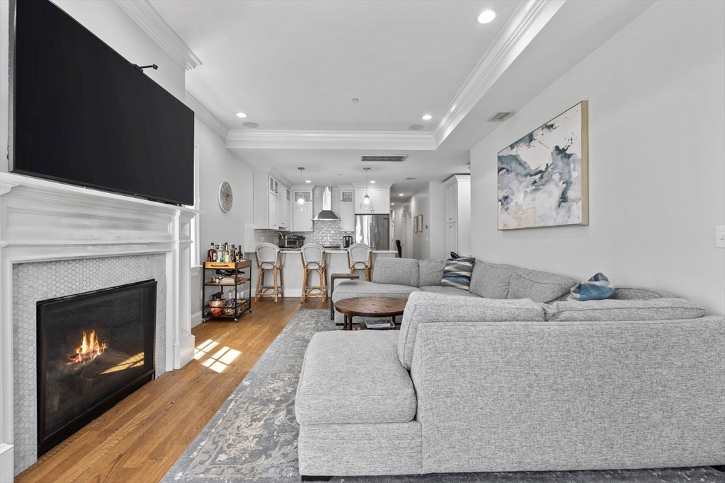 25 Mercer Street, Unit PH5 Boston, MA 02127 - Photo 6 of 22 a living room with furniture and a fireplace