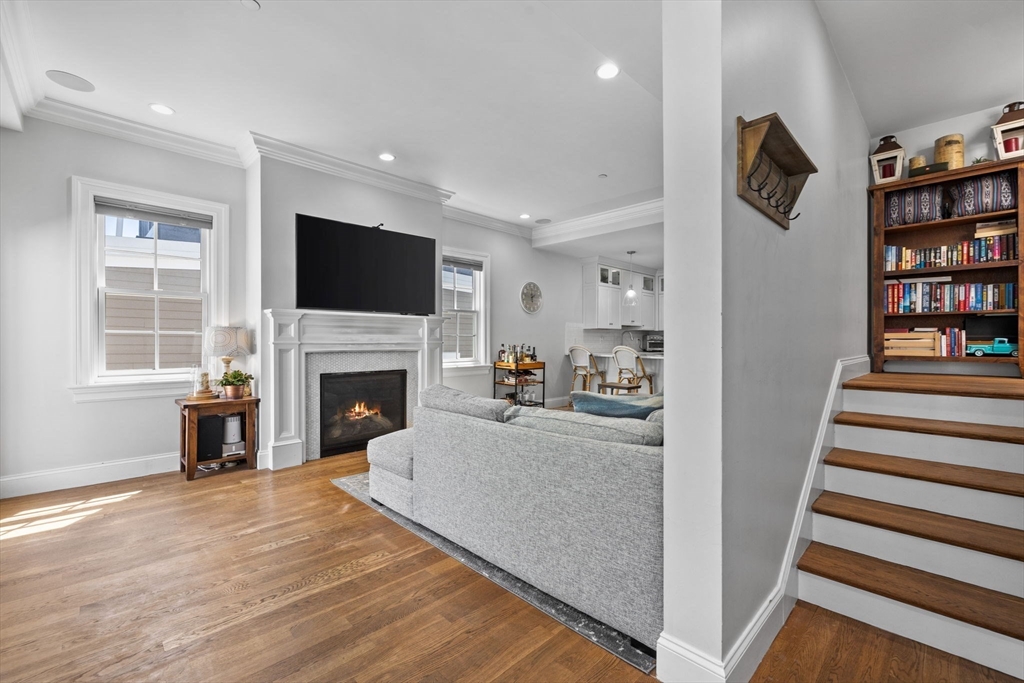 25 Mercer Street, Unit PH5 Boston, MA 02127 - Photo 7 of 22 a living room with furniture a fireplace and a flat screen tv
