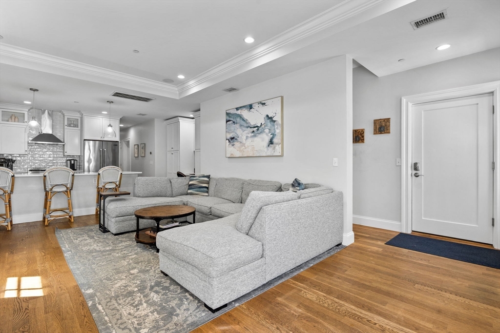 25 Mercer Street, Unit PH5 Boston, MA 02127 - Photo 8 of 22 a living room with furniture and wooden floor