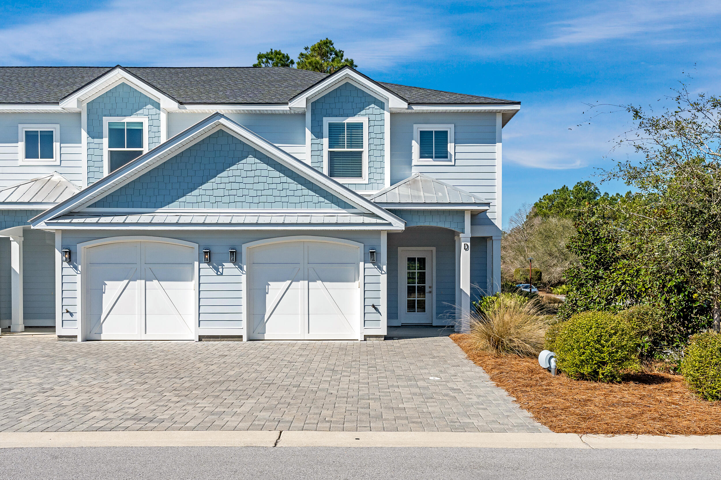 16 Golden Bell Ct Inlet Beach, Unit 16A Inlet Beach, FL 32461 - Photo 1 of 46 a front view of a house with a yard and garage