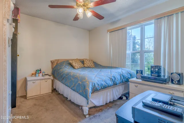 a spacious bedroom with a bed and a chandelier