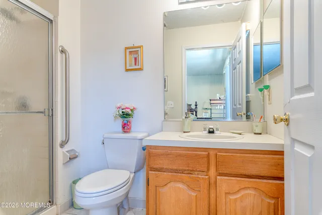 a bathroom with a sink toilet and a mirror