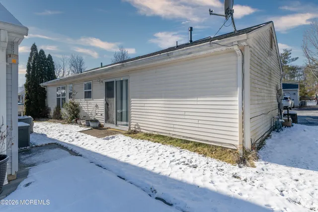 a view of house with backyard and sitting space
