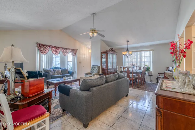 a living room with furniture and a chandelier