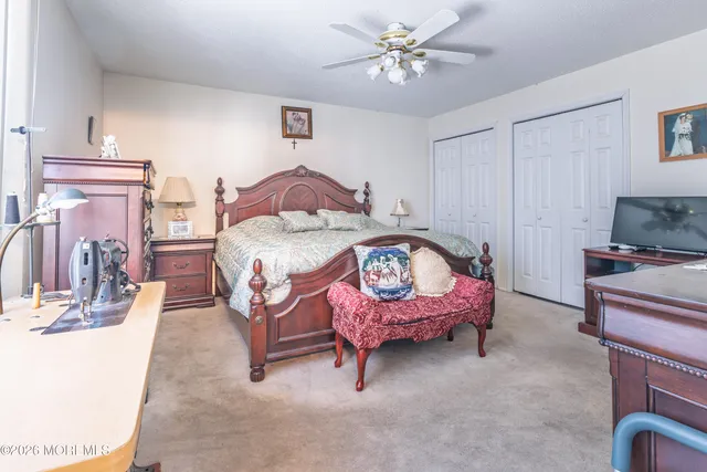 a spacious bedroom with a bed a couch and dresser