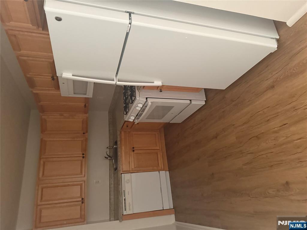 25 Zabriskie Street, Unit 3F Hackensack, NJ 07601 - Photo 3 of 10 a kitchen with a refrigerator sink stove and cabinets