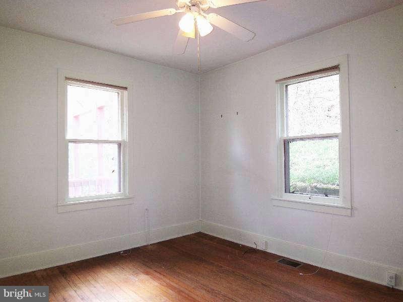 2 Warren Street Berkeley Springs, WV 25411 - Photo 11 of 30 a view of an empty room with wooden floor and a window