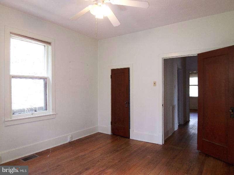 2 Warren Street Berkeley Springs, WV 25411 - Photo 12 of 30 an empty room with wooden floor and windows