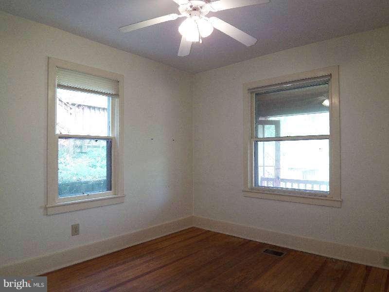 2 Warren Street Berkeley Springs, WV 25411 - Photo 15 of 30 a view of an empty room with wooden floor and a window