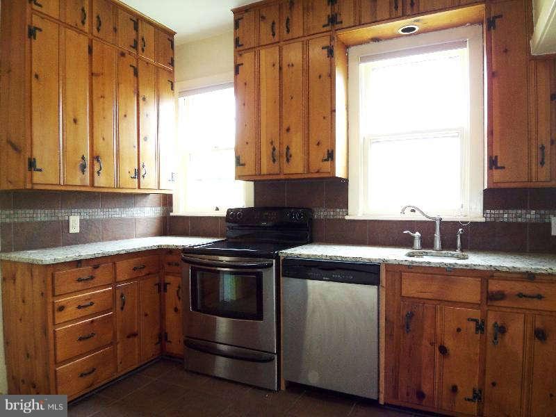 2 Warren Street Berkeley Springs, WV 25411 - Photo 16 of 30 a kitchen with a stove and a sink