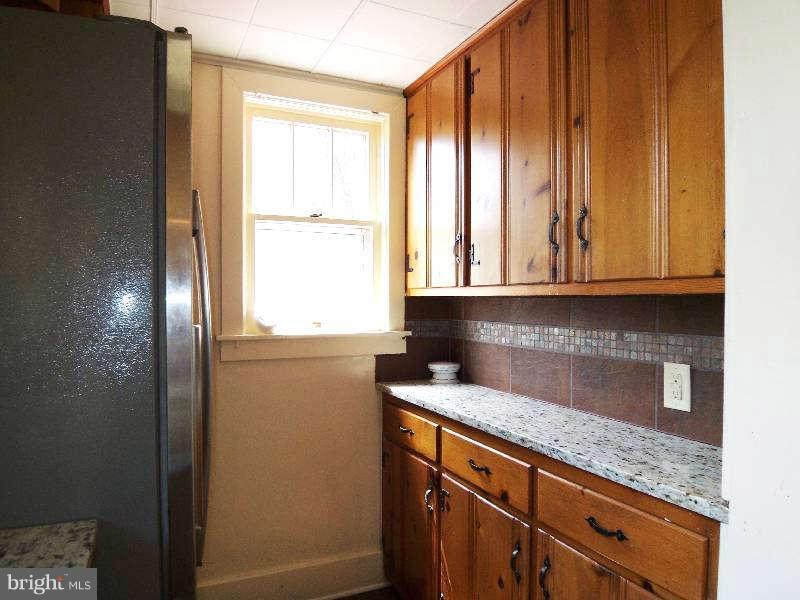 2 Warren Street Berkeley Springs, WV 25411 - Photo 18 of 30 a kitchen with granite countertop cabinets stainless steel appliances and a window