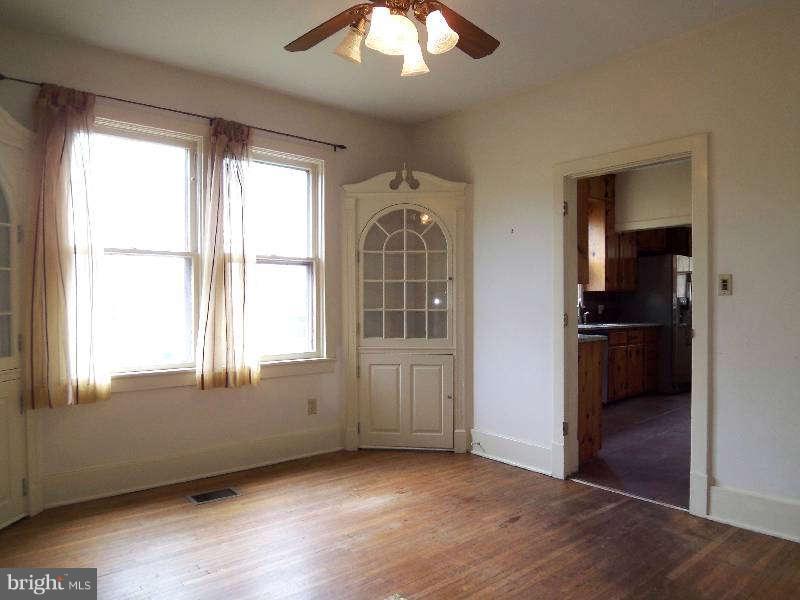 2 Warren Street Berkeley Springs, WV 25411 - Photo 19 of 30 an empty room with wooden floor cabinet and windows