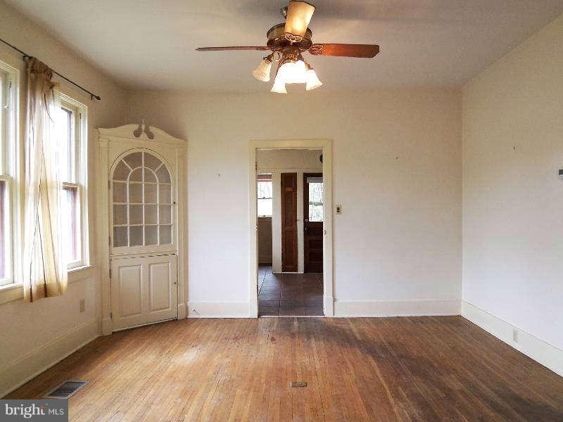 2 Warren Street Berkeley Springs, WV 25411 - Photo 20 of 30 wooden floor in an empty room with a window