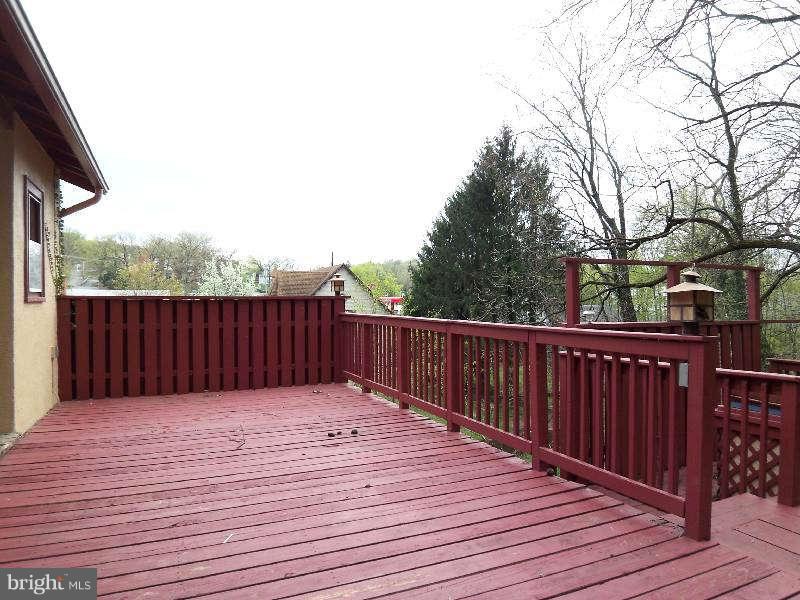 2 Warren Street Berkeley Springs, WV 25411 - Photo 3 of 30 a balcony with wooden floor and fence