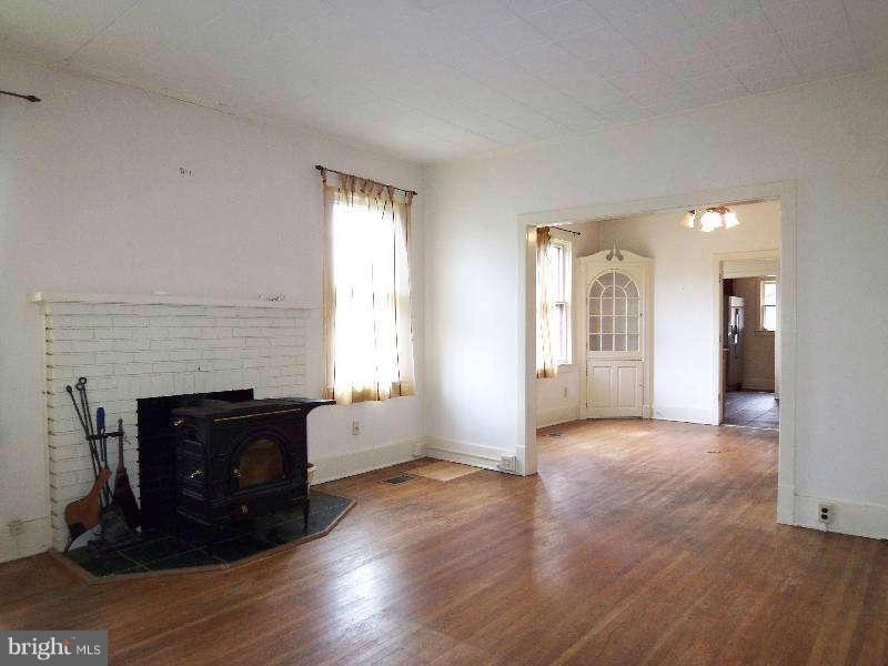 2 Warren Street Berkeley Springs, WV 25411 - Photo 21 of 30 an empty room with windows and fireplace
