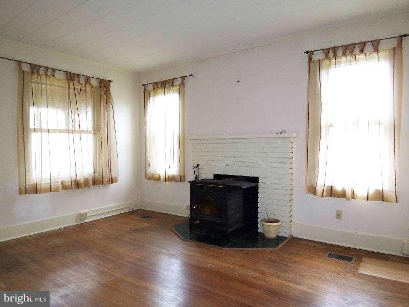 2 Warren Street Berkeley Springs, WV 25411 - Photo 22 of 30 a view of an empty room with wooden floor and a window