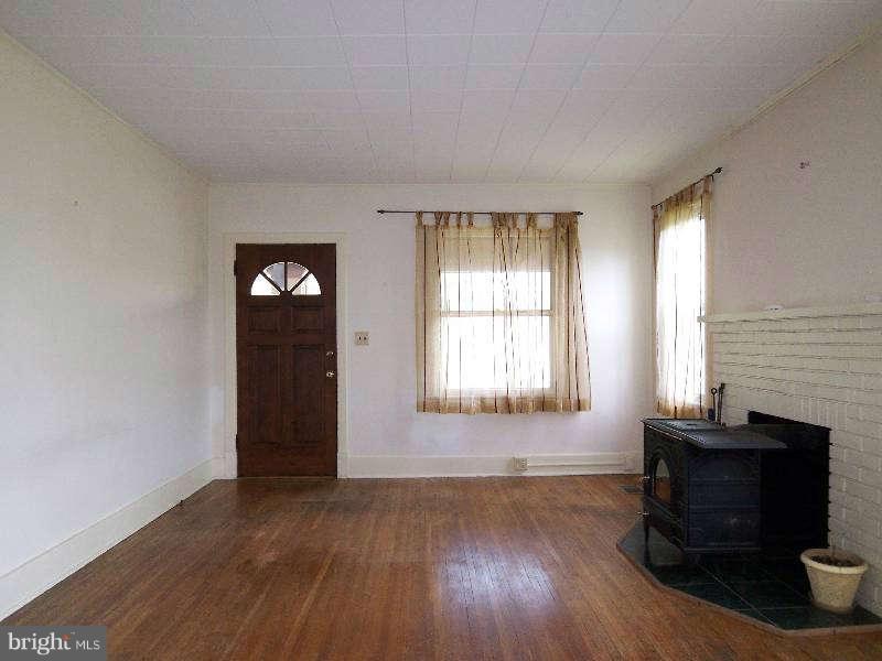 2 Warren Street Berkeley Springs, WV 25411 - Photo 23 of 30 an empty room with wooden floor and windows