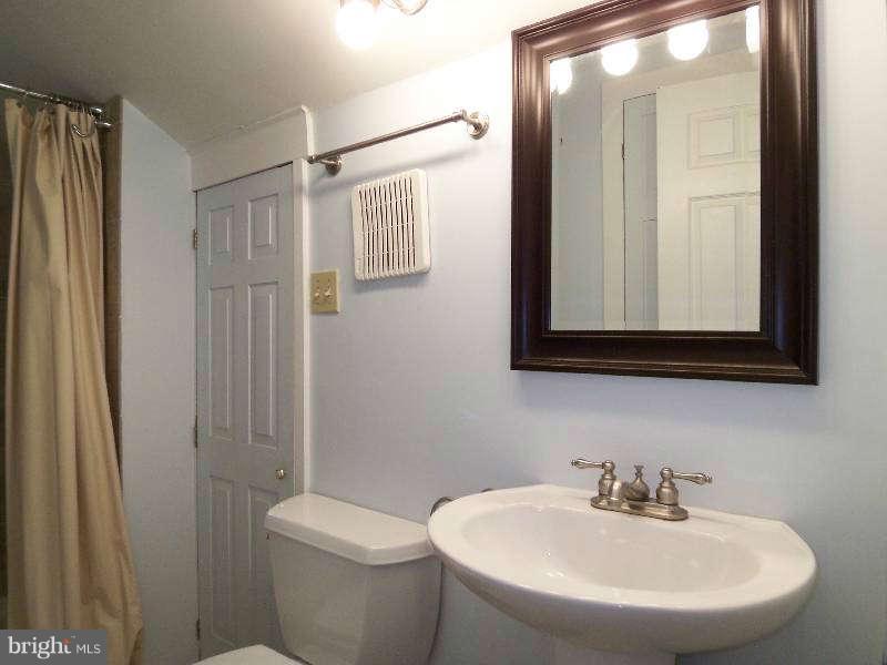 2 Warren Street Berkeley Springs, WV 25411 - Photo 25 of 30 a bathroom with a sink a toilet and shower