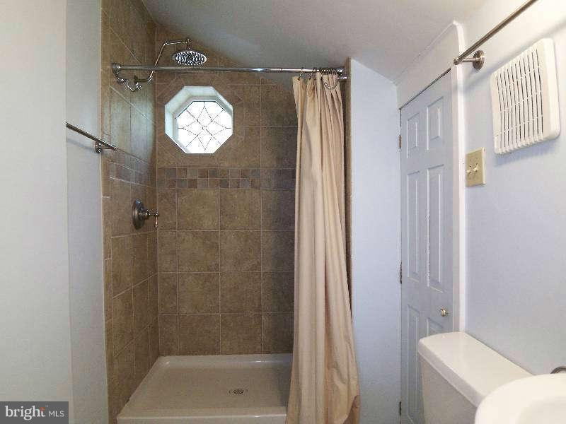 2 Warren Street Berkeley Springs, WV 25411 - Photo 26 of 30 a bathroom with a toilet sink and shower