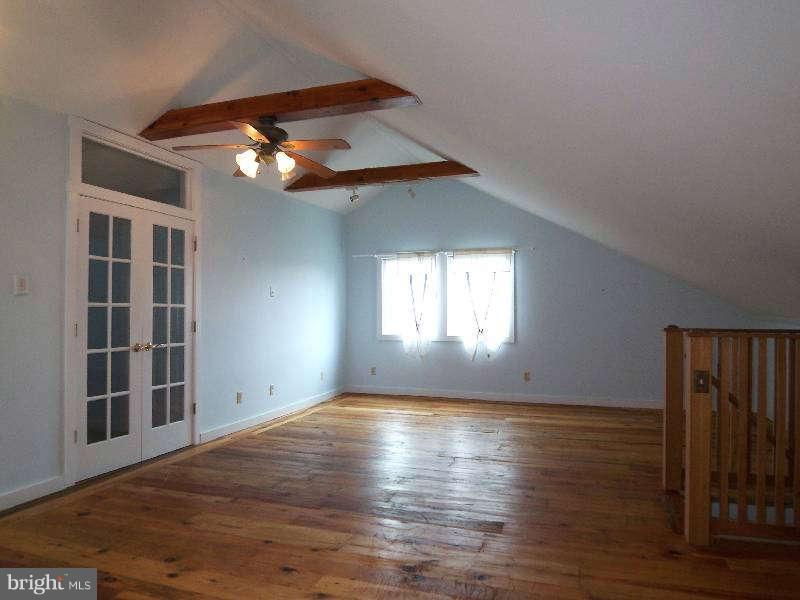 2 Warren Street Berkeley Springs, WV 25411 - Photo 27 of 30 a view of empty room with wooden floor and fan