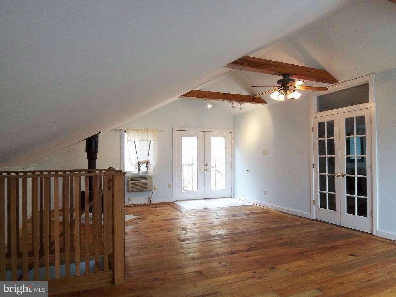 2 Warren Street Berkeley Springs, WV 25411 - Photo 28 of 30 a view of an empty room with wooden floor and a window