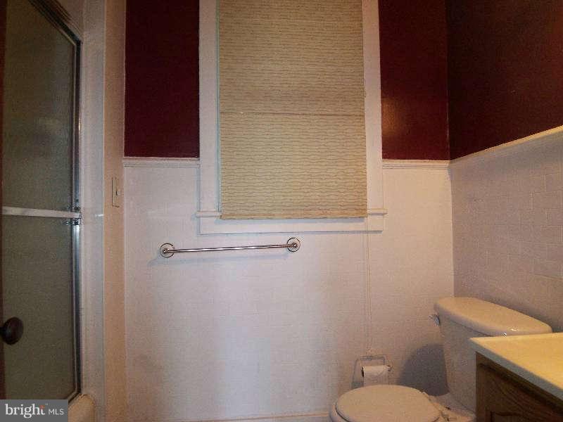 2 Warren Street Berkeley Springs, WV 25411 - Photo 10 of 30 a white toilet sitting next to a shower