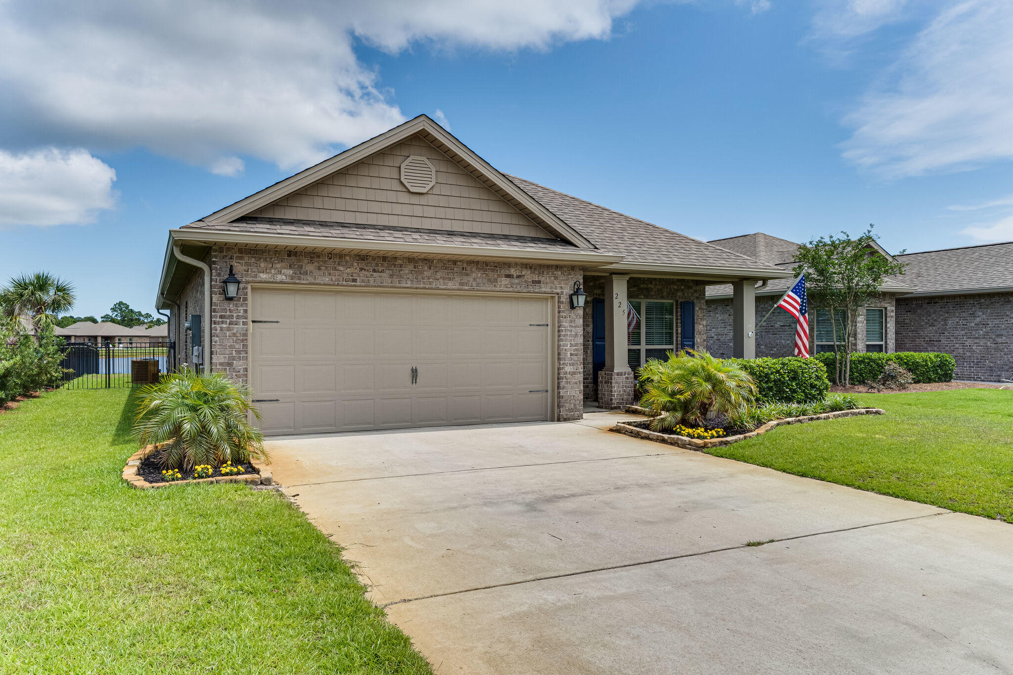 225 Pin Oak Loop Santa Rosa Beach, FL 32459 - Photo 31 of 36 a front view of a house with a yard and garage