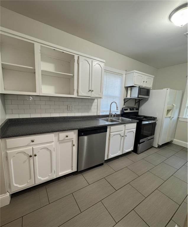 1230 South Madison Avenue Monroe, GA 30655 - Photo 24 of 37 a kitchen with stainless steel appliances granite countertop a sink and a stove