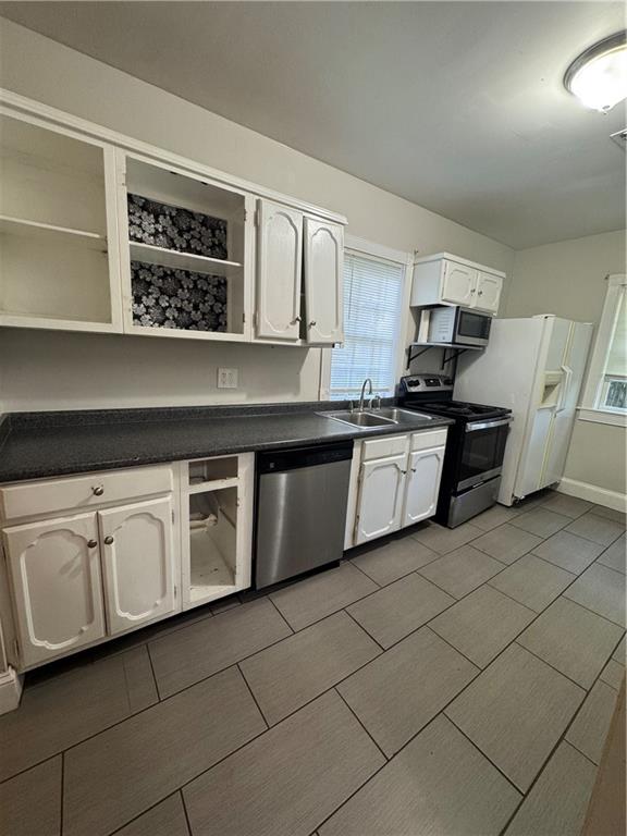 1230 South Madison Avenue Monroe, GA 30655 - Photo 26 of 37 a kitchen with stainless steel appliances granite countertop a sink a stove a microwave and cabinets