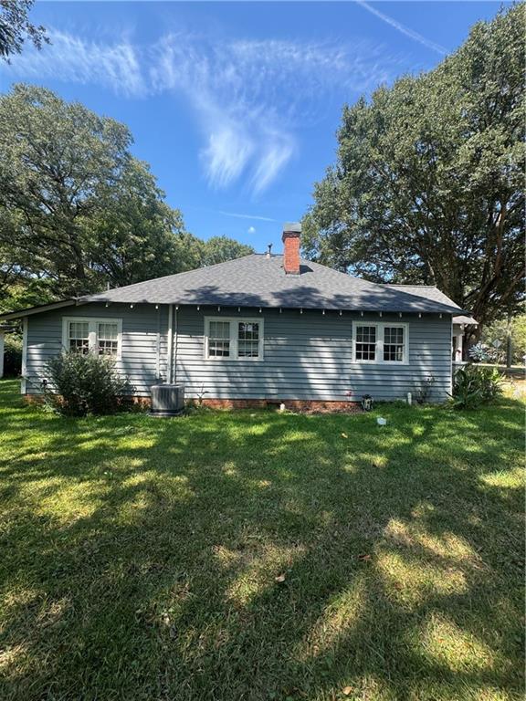 1230 South Madison Avenue Monroe, GA 30655 - Photo 32 of 37 a front view of a house with a garden