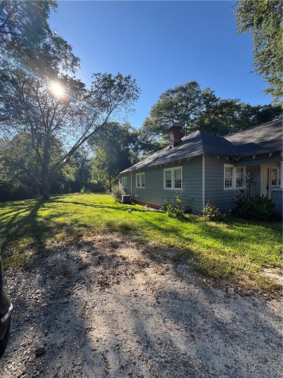 1230 South Madison Avenue Monroe, GA 30655 - Photo 33 of 37 a view of a house with a yard