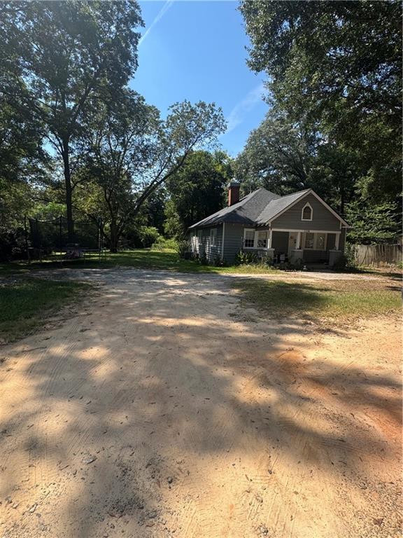1230 South Madison Avenue Monroe, GA 30655 - Photo 36 of 37 a front view of a house with a yard