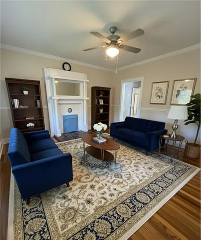 a living room with furniture and wooden floor