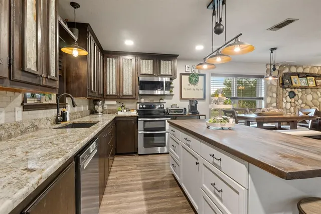a bedroom with a bed and a dresser next to a window