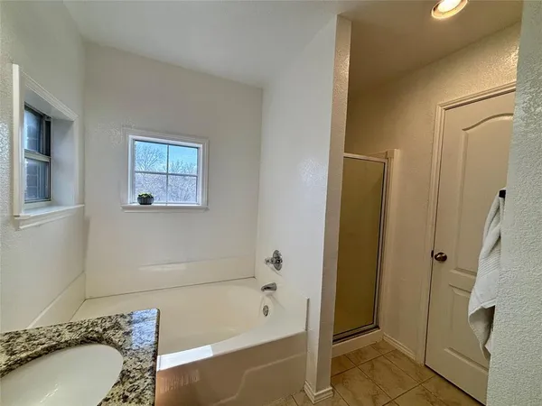 a bathroom with a bathtub and a sink