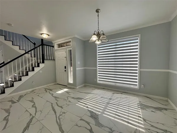 a view of a hallway with a chandelier
