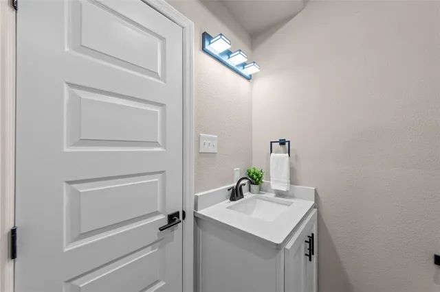 a bathroom with a sink vanity and a mirror