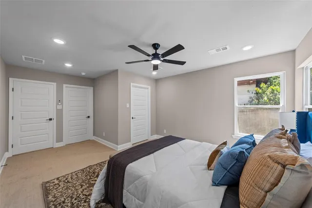 a bedroom with bed and a ceiling fan