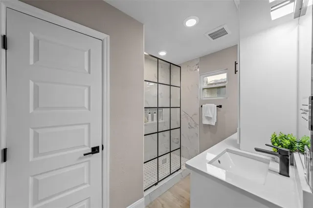 a bathroom with a shower and a sink