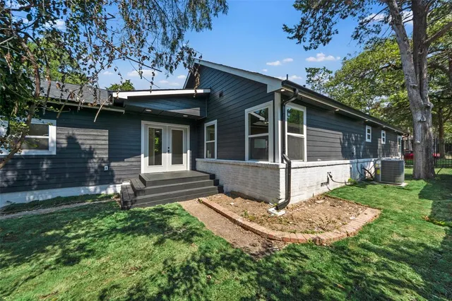 a view of house with a yard and sitting area