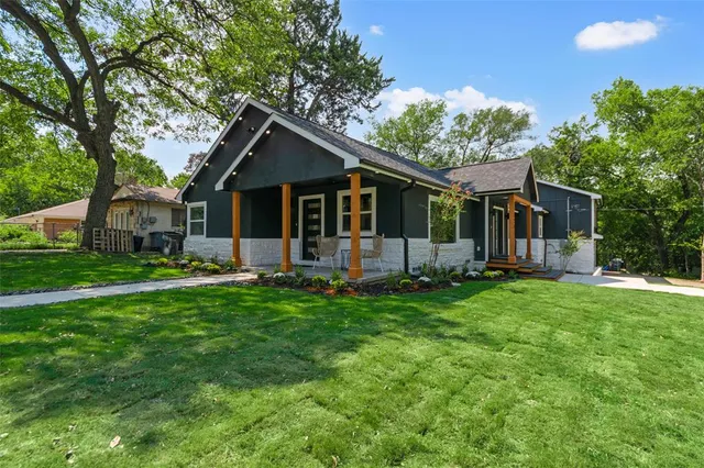 a backyard of a house with table and chairs