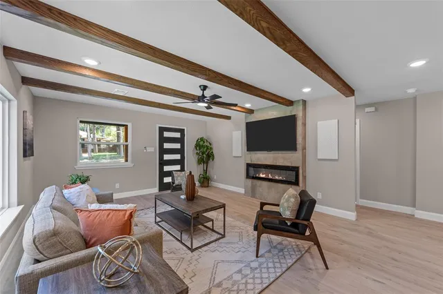 a living room with furniture and wooden floor